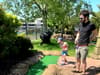 Six-year-old boy accidentally hits his dad between the legs during a game of crazy golf in hilarious video