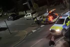 A still from a video uploaded by X account UB1UB2 West London (Southall) of a cow being rammed by a police car in Feltham on June 14, 2024.